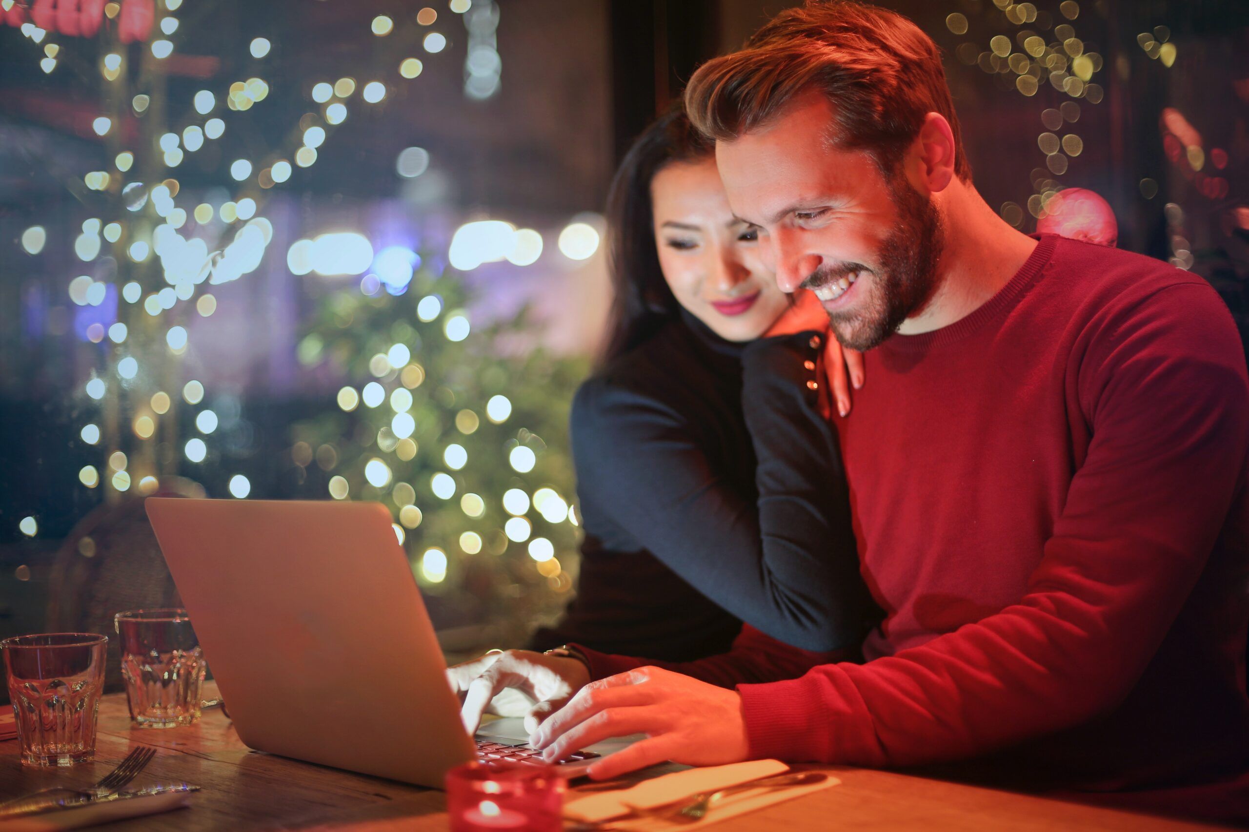 couple-looking-at-laptop-happily