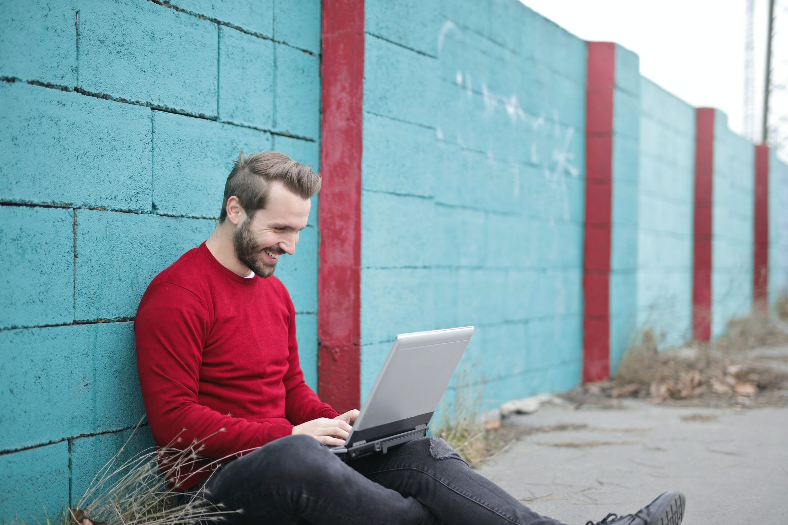 happy-man-using-laptop-on-the-road